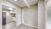 Located at 4706 Yellowstone Blvd, Unit 5 in Houston, TX, this one-bedroom, one-bathroom unit offers a thoughtfully designed single-floor layout. Light wood-style flooring runs throughout the space, complementing the neutral beige and warm white walls that create a clean, cohesive aesthetic. The living area features exposed ceiling beams and a wall-mounted mini-split HVAC system, providing efficient climate control. A ceiling fan with recessed lighting adds comfort to the bedroom, which includes a built-in closet nook and two additional closets for ample storage. Natural light filters into the living area through a window fitted with blinds. The kitchen is a standout feature, equipped with crisp white shaker-style cabinetry with matte black hardware, granite countertops, a stainless steel sink, and a stainless steel range. A window above the counter adds natural brightness. The bathroom maintains the same refined palette, featuring granite countertops on the vanity, white cabinetry, tile-surround tub/shower combo, and a frosted window for privacy. The overall design is clean, modern, and move-in ready, making efficient use of the available space throughout.