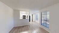 Located at 16465 Henderson Pass in San Antonio, TX, this two-bedroom, one-bathroom unit offers an efficient and well-designed single-floor layout. The open-concept living area features light wood-style flooring and neutral white walls, creating a bright and clean atmosphere. Natural light flows in through multiple windows fitted with horizontal blinds, enhancing the airy feel of the space.

The kitchen is thoughtfully designed with crisp white cabinetry, a subway tile backsplash, white quartz countertops, and a peninsula that opens to the living area. Black appliances — including a refrigerator, electric range, and over-the-range microwave — provide a modern contrast to the light cabinetry. A dedicated pantry with built-in shelving adds valuable storage directly off the kitchen.

Both bedrooms are carpeted and feature ceiling fans with light fixtures. The primary bedroom is generously sized and benefits from dual windows that bring in ample natural light. Each bedroom includes a closet with hanging rod storage. The second bedroom also features a closet and connects conveniently to the rest of the unit.

The bathroom is clean and functional, featuring a full tub-shower combination, white cabinetry for storage, and wood-style flooring. Textured ceilings are consistent throughout the unit, adding a classic touch to the overall design.