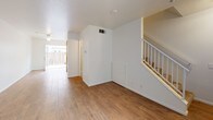 Located at 3680 Monroe St in Riverside, California, this two-story residence offers 2 bedrooms and 1.5 bathrooms across a thoughtfully arranged layout. The main level welcomes you with warm wood-look tile flooring that extends through the open living and entry areas, complemented by crisp white walls and a ceiling fan that enhances airflow and comfort. A staircase with white railings leads to the upper level, and a sliding door provides access to a private outdoor patio or yard area, allowing natural light to fill the main living space. The kitchen is equipped with warm oak cabinetry — both upper and lower — offering generous storage, light countertops, a gas range, and tile flooring, making it a practical and functional cooking space. A convenient half bathroom is located on the main floor, finished with tile flooring and a vanity. Upstairs, both bedrooms are carpeted and feature large windows that invite natural light and offer exterior views of the surrounding neighborhood. One bedroom includes a walk-in closet, providing ample storage. The full bathroom on the upper level includes a single-sink vanity with wood cabinetry, a combined tub and shower, and tile flooring, completing the home's functional and clean aesthetic.