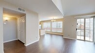 This well-designed 640 square foot apartment offers a harmonious blend of comfort and functionality. The open-concept living area boasts vaulted ceilings, creating an airy atmosphere enhanced by natural light from large windows. Rich wood-look flooring extends throughout the main living spaces, adding warmth and elegance.

The modern kitchen is a standout feature, equipped with stainless steel appliances, ample honey-toned cabinetry, and a convenient center island. Large windows provide a bright cooking environment and views of the surrounding area.

The spacious bedroom, measuring 150 square feet, features plush carpeting and a ceiling fan for added comfort. A sliding glass door leads to a private balcony, perfect for enjoying outdoor views or morning coffee.

The bathroom showcases clean lines with white fixtures and modern finishes. A hallway provides additional storage options and seamlessly connects the living spaces.

A cozy fireplace in the living room adds a touch of ambiance, while the balcony offers an extended living space with views of the property's mature trees. This thoughtfully designed apartment combines modern amenities with comfortable living, making it an ideal home for singles or couples seeking a well-appointed living space.