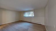 Located at 2135 S Depew St in Denver, CO, this 2-bedroom, 1-bathroom unit offers a thoughtfully arranged single-floor layout. Light wood-style flooring runs throughout, creating a cohesive and clean aesthetic across all rooms.

The spacious primary bedroom features neutral walls, a baseboard heating unit, and a window with vertical blinds that allows natural light to filter in. The second bedroom is similarly appointed, with light flooring, a ceiling fan with integrated lighting, a textured ceiling, and a window overlooking the exterior. Both bedrooms offer a calm, airy atmosphere.

The kitchen is a standout feature, showcasing white shaker-style cabinetry, dark countertops, and a striking black subway tile backsplash. Stainless steel appliances — including a refrigerator, dishwasher, and range — provide a modern, functional cooking space.

The bathroom is well-appointed with a tub-shower combination enclosed by sliding glass doors and floor-to-ceiling marble-style wall panels. A white vanity with dark countertop and light tile flooring complete the clean, updated look.

Connecting the rooms are two hallways that facilitate an efficient flow throughout the unit. The overall design is clean and contemporary, making this Denver unit a comfortable and practical living space.