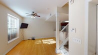 Located at 20 Renewal Rd in Pendleton, South Carolina, this multi-level home spans three floors connected by a carpeted staircase with white railings. The main living area greets with warm hardwood flooring, neutral wall tones, and a ceiling fan that enhances the open, airy feel. Natural light filters through windows, creating a bright and welcoming atmosphere throughout.

The kitchen is a functional highlight, featuring rich dark wood cabinetry, granite countertops, and a full suite of stainless steel appliances including a French door refrigerator, double wall oven, built-in microwave, and a black cooktop. Track lighting and a large overhead fixture illuminate the generous counter and storage space, while the adjoining dining area offers room for everyday meals.

Upper floors are carpeted throughout, providing comfort in the bedrooms, which are well-sized with ceiling fans, ample natural light from multiple windows with blinds, and neutral finishes. The hallway connecting the upper-level rooms is spacious and bright, with ceiling fans adding comfort.

Bathrooms are clean and functional, featuring white vanities, brushed nickel fixtures, a full tub-shower combination with tile flooring, and a compact half bath. The overall design is consistent and practical, offering a comfortable, move-in-ready home in a quiet South Carolina setting.