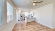 Located at 2800 N Bonnie Brae St in Denton, Texas, this single-story 2-bedroom, 2-bathroom home offers a clean, modern aesthetic with thoughtful design details throughout. The open-concept living and kitchen area serves as the heart of the home, featuring durable wood-look flooring, recessed lighting, and a ceiling fan. The kitchen stands out with two-tone cabinetry — crisp white upper cabinets paired with navy lower cabinets — complemented by a classic white subway tile backsplash, granite countertops, stainless steel appliances, and a peninsula with seating potential. The living area is bright and airy, with multiple windows and a sliding glass door that invites natural light and outdoor access. The spacious primary bedroom includes a ceiling fan, large windows with blinds, and access to a dedicated walk-in closet fitted with built-in shelving and hanging rods. The second bedroom is similarly bright, with a ceiling fan and a window overlooking the exterior. Both bathrooms continue the navy and granite design theme seen in the kitchen, with wood-look flooring and natural light from overhead windows. The entire home maintains a cohesive, contemporary palette of neutral tones, making it a polished and move-in-ready residence.