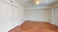Located at 2619 Hydraulic Rd in Charlottesville, VA, this single-floor, 2-bedroom, 1-bathroom unit offers a functional and well-appointed layout. Warm hardwood-style flooring flows consistently throughout every room, creating a cohesive and inviting atmosphere.

The kitchen is a standout feature, offering rich wood cabinetry, dark granite-style countertops, a tile backsplash, and black appliances including a gas range, microwave, and refrigerator. A peninsula counter connects the kitchen to the living area, and an in-unit washer and dryer are conveniently located adjacent to the kitchen.

Both bedrooms are comfortably sized, each featuring ceiling fans, large windows with blinds that allow natural light, and built-in closets with bi-fold doors. The primary bedroom includes crown molding for an added touch of elegance.

A central hallway connects the bedrooms to the full bathroom, which is outfitted with a tub-shower combination, a wood-vanity with a light countertop, and chrome fixtures. The entryway opens to the living space and features hardwood-style flooring and a keypad-equipped front door. The overall design is clean, neutral, and move-in ready.