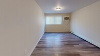 Located at 3583 Alaska Ave in Cincinnati, Ohio, this single-floor, 2-bedroom, 1-bathroom residence offers a practical and well-maintained living environment. The unit is unified by durable wood-look plank flooring that runs consistently throughout all rooms, creating a cohesive and clean aesthetic.

The living room is a comfortable open space equipped with a wall-mounted air conditioning unit and baseboard heating, ensuring year-round climate control. Natural light enters through blinded windows, keeping the space bright and welcoming. Two hallways connect the rooms, providing a logical and functional layout.

The kitchen stands out with its dark espresso cabinetry, granite-style countertops, a stainless steel sink, and a range, offering a modern and practical cooking space. The bathroom features a full tub and shower combination with built-in wall shelving, finished in clean white fixtures.

Both bedrooms are well-proportioned, each featuring windows with blinds for natural light, baseboard heating, wall-mounted air conditioning units, and neutral warm-toned walls. The primary bedroom provides a comfortable and adequately sized personal retreat. Throughout the unit, clean white trim and neutral paint tones contribute to a move-in-ready, functional living space suitable for everyday use.