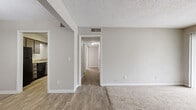 Located at 5099 Linbar Dr in Nashville, TN, this single-floor, 2-bedroom, 4-bathroom unit offers a practical and comfortable layout with a neutral color palette throughout. The living room features plush carpet and a sliding glass door fitted with vertical blinds, allowing natural light to filter in while providing direct access to the outdoors. Wood-look flooring flows through the entryway, hallway, kitchen, and dining areas, creating a cohesive and easy-to-maintain aesthetic. The kitchen is outfitted with dark cabinetry, granite-style countertops, a double sink, a dishwasher, and a full-size refrigerator. A dedicated pantry with built-in shelving provides generous storage space. The adjacent dining room is lit by a pendant light and transitions seamlessly from the kitchen. Both bedrooms are carpeted; the spacious primary bedroom benefits from multiple windows that bring in ample natural light. The bathrooms feature mosaic tile flooring, granite-style vanity countertops, dark cabinetry, and tub-shower combinations. A central hallway connects the bedrooms and bathrooms with ease. Two closets offer additional storage throughout the unit. Textured ceilings are consistent throughout the space, completing this well-organized Nashville unit.