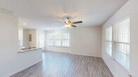 Located at 226 Sun Crisp Path in Georgetown, Kentucky, this two-story home offers a well-designed layout across two floors, featuring three bedrooms, three full bathrooms, and five closets. The main floor opens into a bright, airy living and dining area with light-toned luxury vinyl plank flooring and ceiling fans throughout. Large windows fitted with blinds allow generous natural light to fill the space, creating a clean and welcoming atmosphere. The kitchen is thoughtfully appointed with white shaker-style cabinetry, granite countertops, a subway tile backsplash, and a full suite of stainless steel appliances, including a refrigerator, electric range, built-in microwave, and dishwasher. A dedicated laundry area and convenient hallways round out the main level. The private outdoor patio is enclosed by a white vinyl privacy fence with decorative lattice topping, offering a quiet outdoor retreat. Upstairs, the three bedrooms are carpeted and well-lit, each with ceiling fans and ample closet space. The primary bedroom provides a comfortable retreat with two large windows overlooking the neighborhood. The bathrooms feature clean white tilework, tub-shower combinations, wood-look LVP flooring, and white vanities with brushed nickel hardware.