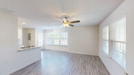Located at 226 Sun Crisp Path in Georgetown, Kentucky, this two-story home offers a well-designed layout across two floors, featuring three bedrooms, three full bathrooms, and five closets. The main floor opens into a bright, airy living and dining area with light-toned luxury vinyl plank flooring and ceiling fans throughout. Large windows fitted with blinds allow generous natural light to fill the space, creating a clean and welcoming atmosphere. The kitchen is thoughtfully appointed with white shaker-style cabinetry, granite countertops, a subway tile backsplash, and a full suite of stainless steel appliances, including a refrigerator, electric range, built-in microwave, and dishwasher. A dedicated laundry area and convenient hallways round out the main level. The private outdoor patio is enclosed by a white vinyl privacy fence with decorative lattice topping, offering a quiet outdoor retreat. Upstairs, the three bedrooms are carpeted and well-lit, each with ceiling fans and ample closet space. The primary bedroom provides a comfortable retreat with two large windows overlooking the neighborhood. The bathrooms feature clean white tilework, tub-shower combinations, wood-look LVP flooring, and white vanities with brushed nickel hardware.