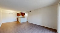 Located at 801 E Alosta Ave in Azusa, CA, this single-floor residence offers a well-organized 1-bedroom, 2-bathroom layout designed for efficient, comfortable living. The living room features light wood-style flooring, neutral walls, a textured ceiling, and a sliding glass door that opens to an outdoor view, filling the space with natural light. Adjacent to the living area, the kitchen is equipped with rich warm-toned wood cabinetry, granite-style countertops, a peninsula breakfast bar, and white appliances including a dishwasher, electric range, and refrigerator — offering ample storage and workspace. A hallway connects the main living spaces to the bedroom and bathrooms, with consistent light wood flooring running throughout. The bedroom is a comfortable, well-proportioned room with plush carpeting, a sliding mirrored closet door, and a window that allows in natural light. Both bathrooms are clean and functional, one featuring a full soaking tub with tiled surrounds, and the other showcasing a warm wood vanity with granite-style countertops and a wall mirror. The overall ambiance is bright, neutral, and move-in ready, making it a practical and inviting home in the Azusa community.