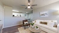 Located at 1720 Lakewood Terr in Belton, MO, this well-appointed single-story home offers 2 bedrooms and 2 bathrooms within a thoughtfully designed floor plan. The open-concept living and dining area is bright and welcoming, featuring wood-look flooring, a ceiling fan with integrated lighting, a textured ceiling, and a large window that fills the space with natural light. The layout flows seamlessly into a galley-style kitchen equipped with white shaker cabinetry, granite-look countertops, stainless steel appliances including a refrigerator, range, microwave, and dishwasher, and tile flooring. The primary bedroom is a comfortable retreat with wood-look flooring, a ceiling fan, a window with natural light, and access to a walk-in closet with wire shelving. The second bedroom also features wood-look flooring, a ceiling fan, and a closet. Both bathrooms are finished with white cabinetry, granite-look countertops, and tile flooring; one includes a shower-tub combination. A hallway connects the living areas to the bedrooms and utility access. Neutral gray tones throughout create a clean, modern aesthetic that is both functional and inviting.
