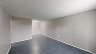 Located at 3400 Garden Oaks Dr in New Orleans, LA, this single-story, one-bedroom, one-bathroom unit offers a functional and efficient layout across a compact yet well-organized floor plan. The living room is the largest area of the home, featuring blue-gray vinyl flooring, neutral gray walls, a textured ceiling, and a front-facing window with blinds that allows natural light to fill the space. A six-panel white front door provides a clean, classic entry point. The galley-style kitchen is thoughtfully laid out with white upper and lower cabinetry, a double stainless steel sink, a coil-top electric range, and a dishwasher. The marbled tile flooring adds visual contrast to the kitchen's neutral palette. The bedroom is a comfortable, well-proportioned room with matching blue-gray flooring, a window for natural light, and access to the hallway. The full bathroom features large-format beige wall tiles surrounding a soaking tub and shower combo, complete with chrome fixtures, a toilet, and a vanity. A dedicated laundry area includes washer/dryer hookups and a built-in shelf, offering practical in-unit convenience. The hallway connects all rooms efficiently, completing this well-organized single-floor layout.