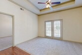This 1080 square foot single-story home in Lewisville, Texas offers a harmonious blend of comfort and functionality. The property boasts three bedrooms, including a primary bedroom of 170 square feet, and two full bathrooms. The open-concept design seamlessly integrates the kitchen and living areas, creating an inviting space for both daily life and entertaining.

The home's interior is characterized by a neutral color palette, with cream-colored walls and warm wooden elements. The living area features plush carpeting, while the kitchen and dining space showcase rich hardwood flooring. Large windows, some adorned with plantation shutters, allow ample natural light to flood the rooms.

The kitchen is equipped with modern appliances, including a built-in microwave and a sleek black refrigerator. Honey-toned wooden cabinetry provides abundant storage space, complemented by a practical breakfast bar.

The bathrooms are thoughtfully designed with neutral-toned tile work, featuring a decorative border that adds a touch of elegance. Each bathroom includes a bathtub with a shower, ensuring both comfort and convenience.

Additional amenities include ceiling fans for improved air circulation and well-designed closet spaces with wire shelving systems. The property's layout efficiently utilizes every square foot, creating a living space that is both comfortable and practical for modern lifestyles.