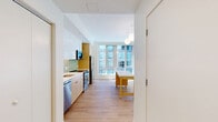 This contemporary townhouse in Baltimore offers 1080 square feet of thoughtfully designed living space across two floors. The home features 2 bedrooms and 3 bathrooms, including a spacious 180 square foot primary bedroom. The open-concept main living area combines the kitchen and living room, creating an ideal space for entertaining. 

The kitchen boasts modern cabinetry, stainless steel appliances, and a stylish green tile backsplash. Large windows throughout flood the space with natural light, enhancing the airy feel of the home. The bathrooms are clean and contemporary, with floating vanities and ample storage.

Hardwood floors run throughout, adding warmth to the crisp white walls. The property's layout includes an entrance, two hallways, and a closet for additional storage. With its sleek finishes and functional design, this townhouse offers a perfect blend of style and comfort in the heart of Baltimore.