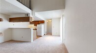 Located at 4941 W 81st Pl in Westminster, Colorado, this one-bedroom, one-bathroom two-story home offers a thoughtfully laid-out floor plan that maximizes every square foot across two levels. The main floor serves as the heart of the home, encompassing a living room, kitchen, bedroom, bathroom, hallway, closets, and a utility room. Soaring vaulted ceilings in the living area create an expansive, airy feel, while a dramatic spiral staircase with a dark metal railing serves as a standout architectural focal point and leads up to the loft on the upper level.

The kitchen features warm wood-toned cabinetry, a countertop with an integrated sink, and hardwood flooring, with ample upper and lower cabinet storage. White appliances, including a full-size refrigerator, complement the functional layout. The bedroom is generously sized with soft carpet flooring and a window that allows natural light to filter in. The bathroom includes a full tub and shower combo surrounded by clean white tile. The upper-level loft, accessible via the spiral staircase, overlooks the main living area and provides flexible additional space. Soft neutral carpeting runs throughout the main living and bedroom areas, contributing to a warm, cohesive ambiance throughout the home.