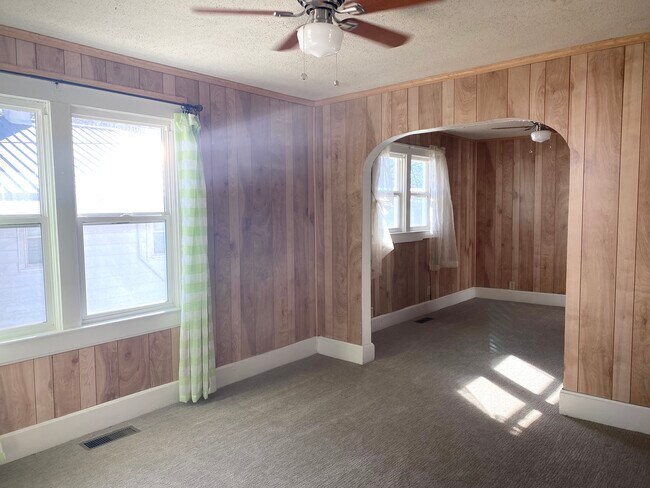 from front door you enter first living area, looking into second living/dining area - 1648 E 8th St N