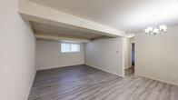 Located at 11 Cobblestone Ct in Pikesville, Maryland, this ground-level unit offers a well-organized layout with a clean, updated aesthetic throughout. The open living and dining area is highlighted by light gray luxury vinyl plank flooring, neutral walls, and structural beam accents that add architectural character to the space. A chandelier in the dining area and recessed ceiling fixtures provide warm, ambient lighting, while windows allow natural light to filter in from outside.

The kitchen is thoughtfully appointed with gray shaker-style cabinetry, granite-look countertops, a single-basin sink, and a full suite of stainless steel appliances including a gas range, over-the-range microwave, and additional units. A window above the sink further brightens the cooking space.

The bedrooms are finished with plush wall-to-wall carpeting and feature windows that bring in natural light, lending each room a calm and comfortable feel. Structural beam detailing is consistent throughout, adding to the unit's distinct character.

The full bathroom is clean and functional, featuring white subway tile surrounding the tub-shower combination, a vanity with gray cabinetry, and light vinyl flooring. The overall design is neutral and move-in ready, offering a practical and inviting living environment.