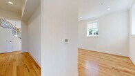 Located in Richmond, Virginia's desirable 23221 zip code, this two-story home offers a generous and well-appointed layout across two floors. Throughout the home, warm natural hardwood floors and crisp white walls create a bright, clean aesthetic that flows seamlessly from room to room.

The main level features an open kitchen-living area anchored by a sleek kitchen with glossy white cabinetry, gold hardware, striking granite countertops, and a bold marble-style backsplash. A separate living room provides ample space with soaring vaulted ceilings and multiple windows that invite abundant natural light and outdoor views.

Upstairs, a dramatic skylight crowns the landing, flooding the upper level with natural light. The spacious primary bedroom offers a generous footprint with its own closet, while three additional bedrooms each feature hardwood floors and wall-to-wall wire shelving closets for optimized storage. The three bathrooms are finished to a high standard, with the primary bath showcasing a double-sink vanity in warm wood tones, gold fixtures, a backlit mirror, marble-patterned tile flooring, and a glass-enclosed walk-in shower.

A dedicated laundry room is equipped with a full-size side-by-side washer and dryer beneath overhead cabinetry with gold hardware. Three hallways and four closets round out the functional and well-organized layout of this exceptional home.