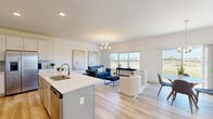 Located at 307 Willow Manor Dr in O'Fallon, MO, this three-floor home offers a thoughtfully designed layout across three well-proportioned levels. The main floor features a bright, open-concept living, dining, and kitchen area finished with light hardwood-style flooring throughout. The kitchen is appointed with white cabinetry, a tile backsplash, stainless steel appliances, recessed lighting, and a central island with a sink and bar seating — ideal for both everyday living and entertaining. The adjoining living area is anchored by a chandelier and large windows that invite abundant natural light and outdoor views. A sliding glass door off the dining area further connects the interior to the outside. The upper floor hosts three bedrooms, including a spacious primary bedroom, along with well-appointed bathrooms featuring clean, white tub-shower combinations. A dedicated laundry area with side-by-side washer and dryer adds everyday convenience. The lower level consists of an unfinished basement with concrete walls, exposed wood-beam ceiling, and windows — offering significant potential for customization. Throughout, the home maintains a clean, modern aesthetic with neutral tones and consistent finishes.