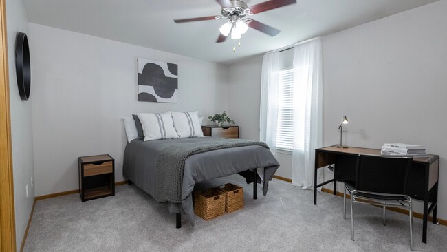 Live life your way! Choose from furnished or unfurnished homes designed for the ultimate student experience. Enjoy spacious, vibrant bedrooms, abundant closet space, and plush carpeting for comfort. - The Row Apartments