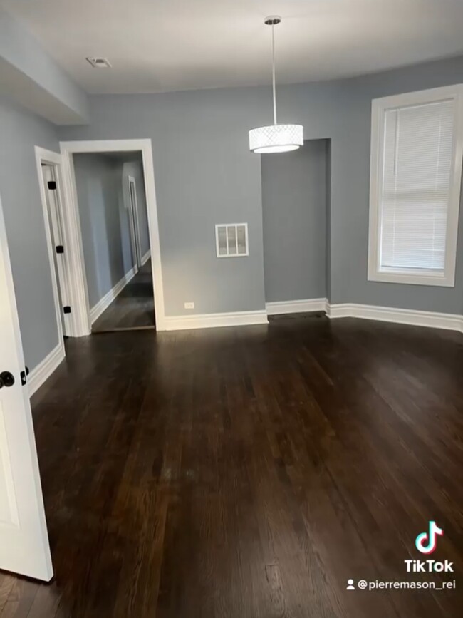 Equally large formal dining room with chandelier lighting and hardwood. - 5733 S Morgan St