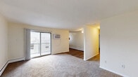 Located at 100 Ross Rd in Bridgeport, PA, this two-bedroom, one-bathroom residence offers a practical and comfortable single-floor layout. The living room serves as the central gathering space, featuring soft carpeted flooring, a wall-mounted air conditioning unit, and a sliding glass door that opens onto a private balcony — bringing in natural light and outdoor access. Baseboard heating is present throughout the unit, ensuring warmth across all rooms.

The two bedrooms are carpeted and finished with neutral wall tones, creating a clean and versatile environment. The spacious primary bedroom features two windows with blinds that allow for ample natural light, while the second bedroom includes a large double-door closet for generous storage. Altogether, the unit includes three closets, providing practical storage solutions throughout.

The bathroom is finished with white subway tile wainscoting, a vanity with under-cabinet storage, a mirrored medicine cabinet with overhead lighting, and clean white fixtures — offering a bright, functional space.

A dedicated kitchen and hallway round out the floor plan, contributing to an efficient and well-organized flow throughout the home. The neutral palette and carpeted floors throughout give the residence a calm, move-in-ready character.