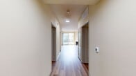 Located at Westerly on Lincoln in Marina Del Rey, CA, this 2-bedroom, 2-bathroom apartment offers 1,090 square feet of well-designed single-floor living space. Wood-style flooring flows consistently throughout the unit, lending a clean, cohesive aesthetic to every room. The open living area features track lighting, a sliding glass door leading to a private balcony with palm tree views, and ample natural light from large windows. The kitchen is efficiently laid out in a U-shape configuration, equipped with black appliances including a gas range, over-the-range microwave, and refrigerator, complemented by light wood cabinetry, dark countertops, and a subway tile backsplash. Both bedrooms are well-proportioned and bright, with large windows that bring in natural light. The primary bedroom measures 180 square feet and includes access to a walk-in closet. Each of the two bathrooms features a light wood vanity with dark countertop, a full-size soaking tub, and a wall mirror. Two hallways provide logical flow between the bedrooms, bathrooms, and main living areas. The unit also includes dedicated closet spaces in both bedrooms, adding practical storage throughout.