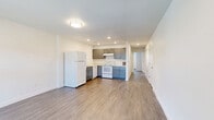 This single-floor, 2-bedroom, 1-bathroom residence in Brighton, Colorado offers a clean, modern aesthetic with a consistent design language carried throughout every room. The interior is finished with durable wood-look plank flooring and crisp white walls, creating a bright and cohesive atmosphere.

The kitchen is a functional centerpiece, featuring gray shaker-style cabinetry, light countertops, recessed lighting, and white appliances including a refrigerator, range, and dishwasher. It flows conveniently into the living area, which offers recessed lighting and ample space for everyday living.

Both bedrooms are well-sized, each featuring wood-look flooring, neutral white walls, and natural light from windows with blinds. The primary bedroom includes a built-in closet with bifold doors and views of the surrounding neighborhood. The second bedroom also features a closet with bifold doors, maintaining the same clean, functional style.

The bathroom is neatly appointed with a gray shaker-style vanity, a large mirror with overhead lighting, a full tub/shower combination, and coordinating wood-look flooring that ties the space together.

Throughout the residence, clean lines, neutral tones, and thoughtful detailing provide a move-in ready environment well-suited for comfortable daily living in Brighton, CO.