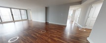 This expansive 1540 square foot apartment, located in The Sterling at 1819 JFK Blvd in Philadelphia, offers a harmonious blend of space and style. The single-level layout showcases an open-concept design that seamlessly integrates the living areas. The heart of the home is a modern kitchen, boasting white cabinetry, stainless steel appliances, and a striking marble-inspired backsplash. A generously sized island with a white countertop provides additional workspace and casual dining options.

The living area is bathed in natural light from floor-to-ceiling windows, offering breathtaking views of the Philadelphia skyline. Rich, warm-toned hardwood floors flow throughout the space, adding a touch of elegance and continuity. The bedroom, measuring 190 square feet, provides ample space for relaxation and storage.

Two well-appointed bathrooms feature contemporary fixtures, including a glass-enclosed shower and a separate bathtub. Multiple closets and storage areas are strategically placed throughout the apartment. The property's thoughtful design maximizes both functionality and aesthetics, creating an ideal urban retreat in the heart of the city.