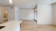 Located at 800 West Pasadena Boulevard in Deer Park, Texas, this efficiently designed single-floor unit offers a thoughtfully arranged layout that maximizes every square foot. The entrance opens into a bright hallway with light wood-style flooring that flows throughout the space, flanked by two closets — one of which features multi-tier wire shelving for organized storage.

The open-concept living, dining, and kitchen area forms the heart of the unit. The kitchen is well-appointed with two-tone cabinetry — white upper cabinets paired with dark lower cabinets — complemented by quartz countertops, a stainless steel undermount sink, and a full suite of stainless steel appliances including a refrigerator, range, microwave, and dishwasher. Pendant lighting above the peninsula adds a contemporary touch. The living area benefits from a ceiling fan, recessed lighting, and windows that invite natural light, with access to a private balcony.

The bathroom features subway tile surrounding a soaking tub and shower combination, brushed nickel fixtures, and neutral tile flooring. A dedicated laundry area adds everyday convenience. The unit's clean, neutral palette and modern finishes create a cohesive, move-in-ready living environment.