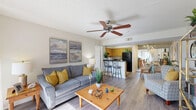 Located at 419 N Briggs Ave in Sarasota, FL, this well-appointed 2-bedroom, 2-bathroom single-story home offers a comfortable and functional layout. The living room is bright and welcoming, featuring wood-look flooring, a ceiling fan, and a sliding glass door that fills the space with natural light and provides outdoor views. The open layout connects the living area seamlessly to both the kitchen and dining room, creating an ideal flow for everyday living and entertaining. The kitchen is well-equipped with warm wood cabinetry, dark granite-style countertops, black appliances, a breakfast bar with seating, and track lighting over the adjacent dining area, which features a mirrored accent wall. The primary bedroom is generously sized with carpet flooring, a large window with outdoor views, and ample closet space. The second bedroom also features carpet flooring and a full closet. Both bathrooms include tub-shower combinations, with one offering a dark granite vanity top and modern light fixtures. The home also includes a dedicated laundry area and four closets for excellent storage. A textured ceiling runs throughout, adding a classic Florida residential character to the space.