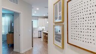 Located at 375 Summer Cypress Cove in Longwood, Florida, this thoughtfully designed single-story residence offers a cohesive blend of modern aesthetics and functional living. Light wood-look flooring flows seamlessly throughout, unifying each space with warmth and continuity.

The kitchen is a standout feature, showcasing crisp white shaker cabinetry extending to the ceiling, quartz countertops, a subway tile backsplash, and a full suite of stainless steel appliances. A spacious island with bar seating and pendant lighting makes it ideal for both meal preparation and casual dining. Natural light filters in through multiple windows fitted with roman shades and blinds.

The living room is bright and welcoming, with large windows dressed in floor-to-ceiling curtains that invite abundant natural light. A ceiling fan adds comfort, while a teal accent wall introduces a refreshing pop of color echoed throughout the home.

The bedrooms are generously proportioned, each benefiting from large windows, light-toned walls, and the same consistent flooring. The primary bedroom features a soothing teal accent wall and ample natural light. Both bathrooms are finished with white vanity cabinetry, quartz countertops, and tub-shower combinations, maintaining the home's clean, contemporary style throughout.