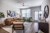 This single-floor, two-bedroom, two-bathroom residence in the Kimbrough area of Memphis, Tennessee, offers a thoughtfully designed layout with contemporary finishes throughout. The open-concept kitchen serves as a central highlight, featuring gray shaker-style cabinetry, quartz countertops, a subway tile backsplash, stainless steel appliances, and a kitchen island with a built-in sink. Wood-style flooring runs through the main living areas, adding warmth and continuity to the space.

The living area is bright and welcoming, with natural light filtering through large windows dressed with blinds and sheer curtains, and a ceiling fan overhead. The adjacent dining area connects seamlessly to both the kitchen and living space, creating an ideal flow for daily living and entertaining.

Both bedrooms are carpeted and well-proportioned, each with ceiling fans and windows that allow natural light. One bedroom features a walk-in closet with built-in shelving. The two bathrooms are finished with dark wood vanities, quartz countertops, and wood-style flooring. One includes a tub-shower combination, while the other offers an elongated vanity with dual sinks. The overall ambiance is clean, modern, and cohesive.