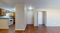 This single-floor unit offers a well-organized layout highlighted by rich, wood-style flooring that runs consistently throughout every room, creating a cohesive and warm aesthetic. The living area is generously proportioned, bathed in ambient light, and features a ceiling fan for added comfort. A dedicated closet with louvered bifold doors provides convenient storage directly off the main living space.

The kitchen is designed for functionality, featuring warm wood-toned cabinetry that extends to the upper and lower levels, dark countertops, and a peninsula-style breakfast bar that separates the kitchen from the living area. White appliances, including a refrigerator and dishwasher, complement the layout, and a sink with overhead cabinetry rounds out the practical workspace.

The bedroom is a comfortable, well-sized retreat with its own ceiling fan, textured ceiling, and two louvered bifold closet doors offering generous storage capacity. The bathroom is clean and straightforward, featuring a tiled tub-shower combination, hardwood-style flooring, a toilet, and a vanity with dark countertop. Throughout the unit, neutral-toned walls, textured ceilings, and consistent flooring tie the spaces together into a practical and livable home.