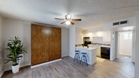 Located at 6320 N 16th St in Phoenix, AZ, this efficiently designed single-floor unit offers a thoughtful layout that maximizes every square foot. The open living area features wood-look plank flooring, soft gray walls, a textured ceiling, and a ceiling fan that promotes comfortable airflow. A large window floods the space with natural light and offers a pleasant outdoor view, creating an airy and welcoming atmosphere.

The galley-style kitchen is well-appointed with white shaker cabinetry, dark granite-style countertops, and a mosaic tile backsplash. Black appliances — including a refrigerator, gas range, and dishwasher — complement the design. A peninsula with a quartz countertop extends into the living area, providing bar seating and additional prep space, making the kitchen as functional as it is attractive.

The bathroom is tastefully renovated, featuring a tub-shower combination with large-format gray tile and striking vertical mosaic accent strips. White subway tile adorns one wall, while a white vanity with a quartz countertop and wood-look flooring tie the room together with a clean, modern aesthetic.

Overall, this unit delivers a cohesive, updated feel with practical finishes suited for comfortable everyday living in the heart of Phoenix.