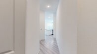 This well-appointed 2-bedroom, 2-bathroom single-story home in Houston, TX offers a clean, modern aesthetic with thoughtful finishes throughout. Light wood-style flooring flows through the main living areas and hallways, lending a bright and cohesive feel to the space. The open-concept kitchen is a standout feature, boasting a large island with striking granite countertops, an undermount sink, white cabinetry with gold-toned hardware, a classic tile backsplash, and stainless steel appliances — all illuminated by elegant pendant lighting. The living area is generously sized, filled with natural light from multiple windows fitted with white blinds, and anchored by a ceiling fan overhead. Both bedrooms offer ceiling fans, natural light, and plush carpeting, with ample closet space — including a walk-in closet outfitted with built-in shelving and hanging rods. The bathrooms are finished with granite-topped white vanities; one features a tiled shower-tub combo, while the other offers a double-sink vanity with wood-look flooring. A dedicated laundry area and six closets throughout the home provide exceptional storage. The overall ambiance is fresh, light-filled, and move-in ready.