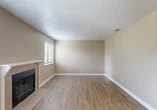 Located at 505 Pioneer Dr in Lodi, California, this single-floor, 2-bedroom, 3-bathroom home offers a practical and comfortable layout with consistent warm-toned finishes throughout. The living room serves as the heart of the home, featuring wood-look laminate flooring, neutral beige walls, a textured ceiling, and a tile-surround fireplace with a classic white mantle — an inviting focal point for the space. Natural light filters in through blinds-covered windows, adding warmth to the open feel of the room. The kitchen is well-appointed with ample white cabinetry extending to the ceiling for generous storage, granite-style countertops, a double-basin sink, and white appliances including a gas range and full-size refrigerator. A pass-through counter connects the kitchen to the adjacent living area, enhancing the open flow of the home. Both bedrooms are carpeted and finished with the same warm neutral palette, each offering a window with outdoor views and closet access. The bathrooms are clean and functional, featuring white vanities with granite-style countertops, wood-look flooring, and tub-shower combinations. This home presents a cohesive, move-in ready interior ideal for comfortable everyday living.
