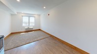 Located at Donna St SW in Grandville, Michigan, this single-floor unit offers a clean, functional layout with a warm, modern aesthetic. The open-concept living and kitchen area is unified by durable wood-look flooring and crisp white walls accented by natural wood baseboards, creating a bright and welcoming atmosphere.

The kitchen is well-appointed with warm-toned wooden cabinetry providing generous storage, granite countertops, a stainless steel sink, and a full suite of stainless steel appliances including an electric range, over-the-range microwave, dishwasher, and refrigerator. The kitchen flows seamlessly into the living area, which benefits from a large window that invites natural light and offers views of the surrounding neighborhood. Recessed lighting adds additional illumination throughout the main living space.

The bathroom is thoughtfully designed with matching warm wood cabinetry, granite countertops, wood-look flooring, and a tub/shower combination. Multiple brushed nickel towel bars and a towel ring provide convenient storage, while textured white walls add subtle depth to the space.

Overall, the unit presents a cohesive and practical design with consistent finishes throughout, making it a comfortable and functional living environment in the Grandville area.