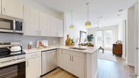 Located in Houston's vibrant North Loop neighborhood, this thoughtfully designed one-bedroom, one-bathroom residence offers a clean, contemporary aesthetic throughout its well-utilized single-floor layout. Light wood-tone flooring and crisp white walls run throughout the space, creating a bright and cohesive atmosphere.

The open-concept kitchen is a standout feature, equipped with stainless steel appliances including a side-by-side refrigerator with ice maker, range, over-the-range microwave, and dishwasher. White shaker cabinetry with brushed nickel hardware, a subtle tile backsplash, and light quartz countertops with a peninsula sink provide both functionality and style. Pendant lighting accents the kitchen and transitions seamlessly into the living area.

The living room is well-lit by natural light streaming through French doors that open to a private balcony, complemented by a ceiling fan and recessed lighting. The bedroom benefits from large windows offering ample natural light and connects directly to the full bathroom, which features a single vanity with quartz countertop, a large framed mirror, and a glass-enclosed shower.

Three closets—including a spacious walk-in with built-in shelving and hanging rods—provide generous storage. An in-unit laundry area and additional closet space round out this efficiently designed home.