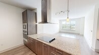 Located at 181 N. Pottstown Pike in Exton, PA, this well-appointed single-floor residence offers 1 bedroom and 2 full bathrooms within a thoughtfully designed layout. The open-concept kitchen and living area serves as the heart of the home, featuring sleek dark wood cabinetry, stainless steel appliances including a French door refrigerator, granite countertops, and light wood-style flooring that flows throughout. A built-in desk niche with open shelving adds a functional workspace element to the common area. The living room is bright and airy, with large windows framing outdoor views of the surrounding greenery and neighborhood. The generously sized primary bedroom includes plush carpeting, a ceiling fan, and a large window with scenic views. A spacious walk-in closet with full wire shelving and hanging systems provides ample storage. The primary bathroom is elegantly finished with a double-sink granite vanity, warm wood cabinetry, modern lighting, large-format tile flooring, and a glass-enclosed walk-in shower. A second bedroom with soft carpeting and a second full bathroom complete this refined and functional residence in the heart of Chester County.
