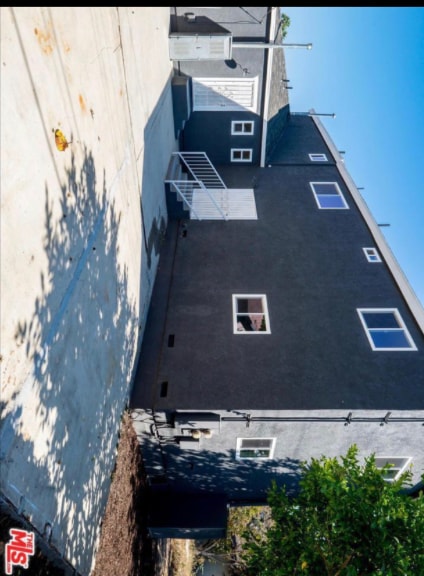 Entry to Rear Two Bedroom Unit. Also pictured: parking spot. - 3959 S Van Ness Ave