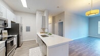 Located at 3550 Esplanade Way in Tallahassee, FL, this single-floor, 3-bedroom, 2-bathroom residence offers a thoughtfully designed layout with contemporary finishes throughout. The open-concept kitchen and living area serves as the heart of the home, featuring sleek gray shaker cabinetry, white quartz countertops, a stainless steel appliance suite including a range, microwave, and refrigerator, and a large peninsula with an undermount sink — ideal for both cooking and casual dining. Wood-look flooring flows seamlessly throughout the entire space, lending a clean, cohesive aesthetic.

Each of the three bedrooms is generously proportioned, with the spacious primary bedroom offering ample room for furnishings. All bedrooms are fitted with ceiling fans, large windows with blinds that bring in abundant natural light, and views of surrounding greenery. Two dedicated closets provide convenient storage.

The two bathrooms are finished with white vanities, quartz countertops, and shower-tub combinations with curtained enclosures, maintaining the home's clean, modern style. Neutral gray-toned walls throughout create a bright and welcoming ambiance, making this a comfortable and functional living space.