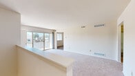 Located on Regency Drive in York, PA, this two-bedroom, one-bathroom residence offers a well-organized single-floor layout designed for comfortable everyday living. The spacious living room features soft carpeting and large sliding glass doors that flood the space with natural light and open to an outdoor balcony with views of the surrounding neighborhood. A half-wall partition subtly defines the transition between the living area and the rest of the unit, adding architectural interest without sacrificing the open feel.

The kitchen is equipped with dark espresso cabinetry, stainless steel appliances including a range and over-the-range microwave, a refrigerator, and a dishwasher. Light wood-look flooring runs throughout the kitchen and dining area, which benefits from its own window overlooking the exterior.

The primary bedroom is generously sized, carpeted, and features a sliding-door closet alongside an additional door for extra storage. The second bedroom is similarly carpeted and includes its own closet. Both rooms receive natural light through windows with neighborhood views.

The full bathroom is cleanly appointed with a single-sink vanity with white countertops, wood-look tile flooring, and a tub/shower combination. A dedicated in-unit laundry area with an Amana top-load washer adds convenience. Four closets throughout the unit provide ample storage across the layout.