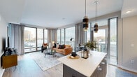 Located at 600 N Glebe Rd in Arlington, VA, this thoughtfully designed single-floor residence offers a seamless blend of modern aesthetics and functional living. The open-concept layout connects the living and kitchen areas, creating a spacious, airy feel bathed in natural light from expansive floor-to-ceiling windows that frame panoramic views of the surrounding Arlington skyline and neighborhood.

The contemporary kitchen is a standout feature, showcasing two-tone cabinetry with light wood uppers and deep navy-blue lower cabinets, crisp white quartz countertops, stainless steel appliances, and a generously sized center island with bar seating illuminated by stylish pendant lighting. The living area extends naturally from the kitchen, with large corner windows maximizing light and views from multiple angles.

The bedroom spaces are carpeted and bright, with ample natural light and room for a dedicated workspace complete with built-in shelving and a integrated desk. The bathroom features clean white finishes, warm wood-tone flooring, and a glass-enclosed walk-in shower. Throughout the residence, light hardwood flooring, neutral tones, and thoughtful details contribute to a polished, contemporary ambiance ideal for modern urban living.