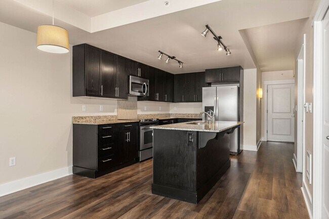 Foto del edificio - Modern 1-Bedroom + Den Condo with Parking, Storage & Rooftop Access – Marselle Condominiums