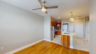 This well-appointed one-bedroom, one-bathroom residence in Baton Rouge, Louisiana offers a thoughtfully designed single-floor layout that maximizes both function and style. The open-concept living and kitchen area serves as the heart of the home, where warm hardwood floors transition seamlessly into large-format marble-look porcelain tile. The kitchen is a standout feature, boasting rich wood cabinetry with sleek hardware, a full suite of stainless steel appliances including a refrigerator, range, and microwave, and a mosaic tile backsplash that adds texture and depth. A curved quartz-topped island with an undermount sink and pendant lighting above creates an ideal space for both meal preparation and casual dining. A convenient in-unit stacked washer and dryer is tucked just off the kitchen. The living area is bright and airy, illuminated by natural light from multiple windows with blinds and complemented by a ceiling fan. The bedroom is a calm, comfortable retreat with hardwood flooring, a ceiling fan, and a window offering natural light. The bathroom is finished to a high standard, featuring large marble-look floor and wall tiles, a vessel sink atop a dark vanity, a glass-enclosed tub and shower combination, and recessed lighting throughout.