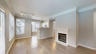 Located at 2350 Bagby St in Houston's vibrant Midtown neighborhood, this well-appointed 3-bedroom, 2-bathroom residence offers a thoughtfully designed single-level layout. The open-concept living and dining areas are anchored by a classic white-mantel fireplace and finished with light hardwood-style flooring that carries throughout the home. Crown molding and neutral gray walls lend a clean, polished aesthetic, while track lighting provides flexible illumination. The kitchen features a peninsula breakfast bar, stainless steel refrigerator, white cabinetry, and a large window that fills the space with natural light. A dedicated pantry adds practical storage. The primary bedroom is generously sized and connects directly to an en-suite bathroom and a spacious walk-in closet outfitted with wire shelving. Two additional bedrooms offer ample natural light through large windows and ceiling fans, making them well-suited as guest rooms or a home office. The second bathroom includes a full tub/shower combo. A dedicated laundry room houses a full-size washer and dryer alongside additional storage. With four closets total and a welcoming entrance hallway, this residence balances comfort and functionality throughout.