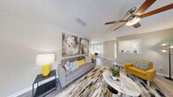 Located at 100 Summerwalk Parkway in Tucker, GA, this thoughtfully designed single-floor residence offers 2 bedrooms and 3 bathrooms across a comfortable and functional layout. The living room serves as the heart of the home, featuring wood-look flooring, a ceiling fan, and a tiled fireplace flanked by large windows that invite natural light. A half-wall with a column detail defines the space while maintaining an open, airy feel throughout.

The kitchen is well-equipped with gray shaker-style cabinetry, subway tile backsplash, light stone countertops, and stainless steel appliances including a gas range. It opens directly to a sun-filled dining area framed by a bay-style window arrangement, offering pleasant outdoor views. The primary bedroom features plush carpeting, a ceiling fan, and direct access to a walk-in closet with wire shelving. The second bedroom also offers carpeted flooring and ample space. Three bathrooms provide convenience for residents and guests alike. An in-unit laundry area accommodates a full-size washer and dryer with overhead shelving for storage. The overall ambiance is bright, neutral, and move-in ready, with consistent wood-look flooring unifying the main living areas.