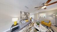 Located at 100 Summerwalk Parkway in Tucker, GA, this thoughtfully designed single-floor residence offers 2 bedrooms and 3 bathrooms across a comfortable and functional layout. The living room serves as the heart of the home, featuring wood-look flooring, a ceiling fan, and a tiled fireplace flanked by large windows that invite natural light. A half-wall with a column detail defines the space while maintaining an open, airy feel throughout.

The kitchen is well-equipped with gray shaker-style cabinetry, subway tile backsplash, light stone countertops, and stainless steel appliances including a gas range. It opens directly to a sun-filled dining area framed by a bay-style window arrangement, offering pleasant outdoor views. The primary bedroom features plush carpeting, a ceiling fan, and direct access to a walk-in closet with wire shelving. The second bedroom also offers carpeted flooring and ample space. Three bathrooms provide convenience for residents and guests alike. An in-unit laundry area accommodates a full-size washer and dryer with overhead shelving for storage. The overall ambiance is bright, neutral, and move-in ready, with consistent wood-look flooring unifying the main living areas.