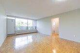 This well-laid-out 2-bedroom, 1-bathroom unit at 1219 Dundas St W in Mississauga offers a comfortable and functional single-floor living space. Warm parquet flooring flows consistently throughout the living areas, hallways, and both bedrooms, lending a classic and cohesive character to the home.

The living room is a standout feature, boasting a large floor-to-ceiling window that frames lush treetop views and fills the room with abundant natural light. The kitchen is thoughtfully updated with grey cabinetry, granite-style countertops, a tile backsplash, and white appliances including a refrigerator and stove, all set on light-toned flooring.

Both bedrooms are bright and well-proportioned, each featuring windows with views of the surrounding greenery and baseboard heating. The primary bedroom offers generous space and connects conveniently to the hallway, which also includes a built-in closet for added storage.

The bathroom is clean and functional, featuring a full tiled tub-shower combination with a window for natural ventilation. Two hallways provide smooth circulation throughout the unit, with a dedicated closet adding practical storage. Overall, the space offers a comfortable, light-filled environment in a convenient Mississauga location.
