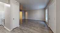 Located at 808 E Sanford St in Arlington, TX, this single-story, 3-bedroom, 2-bathroom home offers a practical and comfortable layout across a well-utilized floor plan. The living areas feature wood-look laminate flooring in a neutral gray tone, creating a cohesive and modern feel throughout the common spaces. Natural light filters in through multiple windows fitted with blinds, brightening the living room and entry area. The spacious living room provides an open canvas, with a secondary entry area that connects smoothly to the rest of the home. The galley-style kitchen is equipped with white cabinetry, a stainless steel sink, light stone-look countertops, and white appliances including a gas range and refrigerator, making efficient use of the available space. All three bedrooms are finished with plush carpeting for added comfort, and each includes a ceiling fan. The generously sized primary bedroom offers ample room and dedicated closet space. The two full bathrooms each feature a tub-shower combination with white tile surrounds and wood-look flooring, maintaining a clean and uniform aesthetic. Three closets throughout the home provide practical storage solutions. The overall design is clean, neutral, and move-in ready.